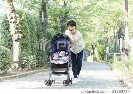 Middle woman pushing a stroller Middle woman pushing a stroller 35565774