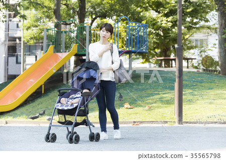 Middle woman pushing a stroller Middle woman pushing a stroller 35565798