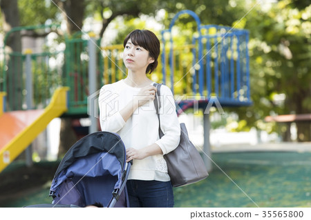 Middle woman pushing a stroller Middle woman pushing a stroller 35565800
