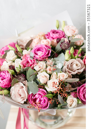 beautiful bouquet of mixed flowers into a vase on 35567321