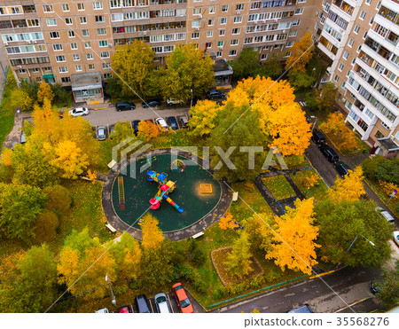 Childrens playground in yard of house in autumn in 35568276