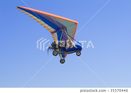 Extreme flight on deltaplane in a blue sky Extreme flight on deltaplane in a blue sky 35570448