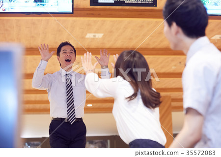 Business person enjoying bowling Business person enjoying bowling 35572083