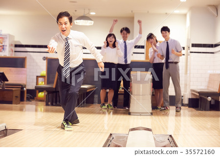 Business person enjoying bowling Business person enjoying bowling 35572160