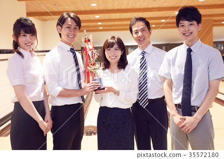 Business person enjoying bowling Business person enjoying bowling 35572180