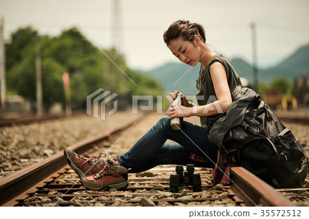 Woman backpacker going to the railway 35572512