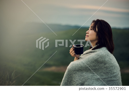 Female backpacker relaxing on the lake Female backpacker relaxing on the lake 35572901