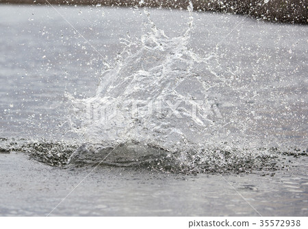 water splashing from a stone in the river 35572938