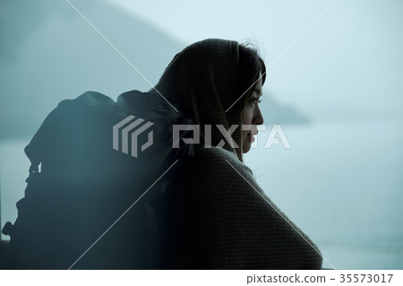 Woman backpacker lakeside portrait 35573017