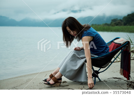 Female backpacker relaxing on the lake Female backpacker relaxing on the lake 35573048