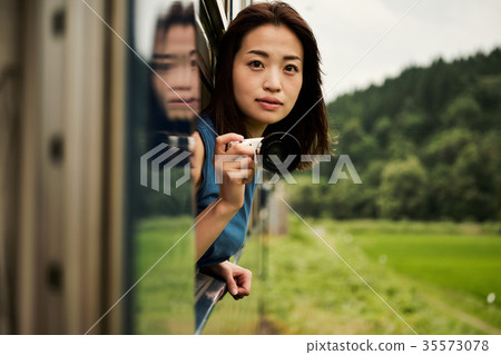 Female backpacker taken from the car window Female backpacker taken from the car window 35573078