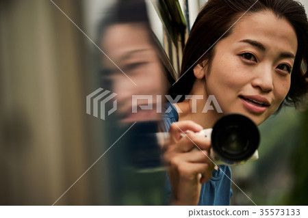 Female backpacker taken from the car window Female backpacker taken from the car window 35573133