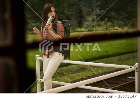 Woman backpacker station home 35573147