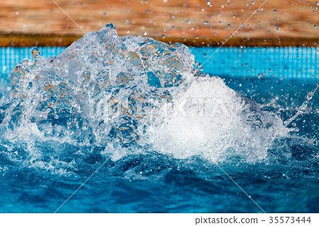 Splashing water in the pool as a background Splashing water in the pool as a background 35573444