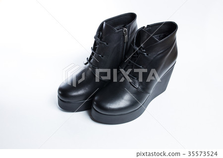 Female black boots isolated on a white background. Female black boots isolated on a white background. 35573524