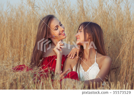 Two women are smiling. 35573529