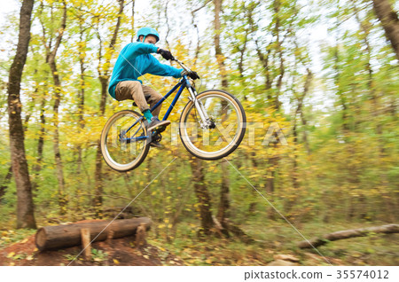 a young guy in a helmet flies landed on a bicycle a young guy in a helmet flies landed on a bicycle 35574012