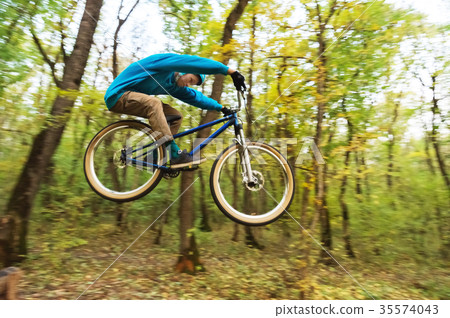 a young guy in a helmet flies landed on a bicycle a young guy in a helmet flies landed on a bicycle 35574043