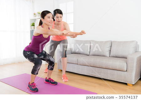 smiling girl training body and making squatting smiling girl training body and making squatting 35574137