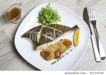 Fried flounder with zucchini, tomatoes and arugula Fried flounder with zucchini, tomatoes and arugula 35574540
