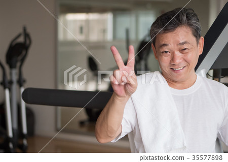 senior man in gym, giving victory hand sign senior man in gym, giving victory hand sign 35577898