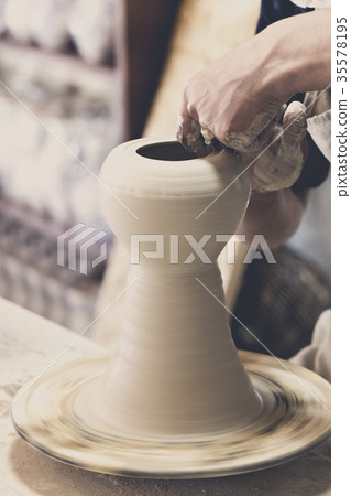 Potter makes pottery handmade in the workshop  35578195