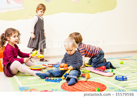 Three kids playing with toys Three kids playing with toys 35579598