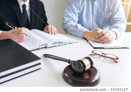 Close up of gavel, Male lawyer or judge Consult with client and Close up of gavel, Male lawyer or judge Consult with client and 35581527