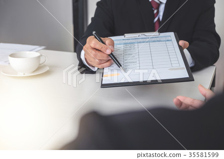 Employment and recruitment concept, Board reading a resume durin 35581599