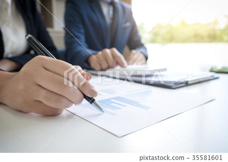 Business team two executive colleagues discussing and analysis w 35581601