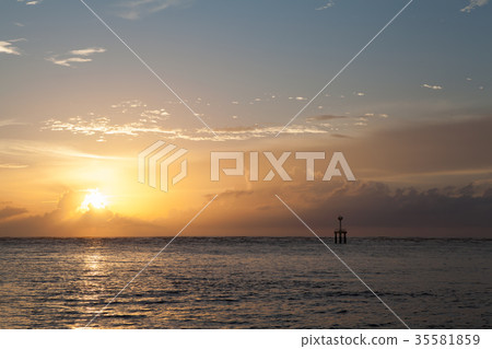 sunset on the beach with lighthouse 35581859