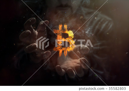 Burning bitcoin symbol and man in the background Burning bitcoin symbol and man in the background 35582803