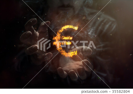 Burning symbol of euro with man in the background Burning symbol of euro with man in the background 35582804