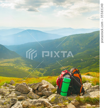 Two backpacks in mountains together Two backpacks in mountains together 35583140