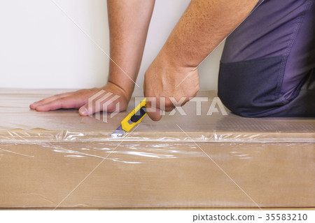Man with knife on box Man with knife on box 35583210