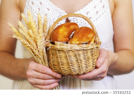 Woman with buns in basket Woman with buns in basket 35583252