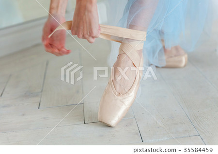 Ballerina puts pointe shoes 35584459