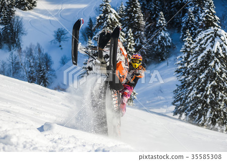 Rider on the snowmobile in the mountains ski Rider on the snowmobile in the mountains ski 35585308
