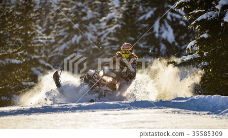 Rider on the snowmobile in the mountains ski Rider on the snowmobile in the mountains ski 35585309