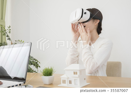 A woman checking a house scheduled for construction with a virtual image A woman checking a house scheduled for construction with a virtual image 35587007