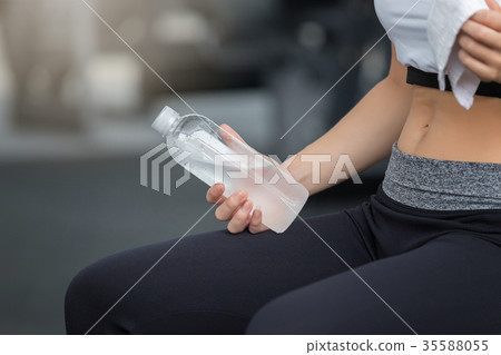 Fitness woman drinking water from bottle Fitness woman drinking water from bottle 35588055