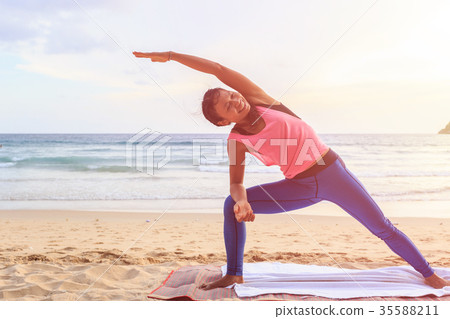 Woman playing Yoga and exercise on the tropical beach in Thailand 35588211