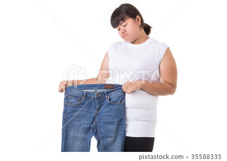 Fat asian woman trying to wear small size jeans isolated on white. Fat and Healthcare concept 35588335