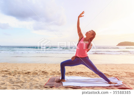 Woman playing Yoga and exercise on the tropical beach in Thailand Woman playing Yoga and exercise on the tropical beach in Thailand 35588385