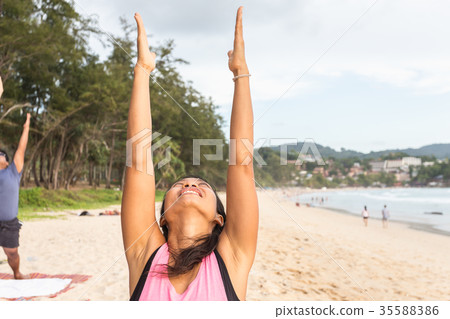 Woman playing Yoga and exercise on the tropical beach in Thailand Woman playing Yoga and exercise on the tropical beach in Thailand 35588386