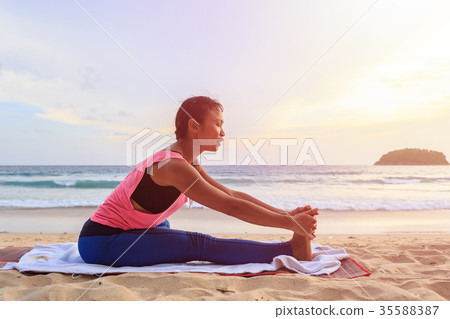 Woman playing Yoga and exercise on the tropical beach in Thailand Woman playing Yoga and exercise on the tropical beach in Thailand 35588387