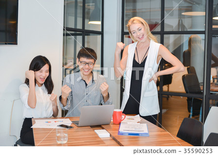 Group of business people meeting in a meeting room, sharing thei Group of business people meeting in a meeting room, sharing thei 35590253