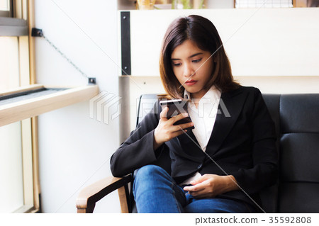 Business woman using smartphone checking e-mail 35592808