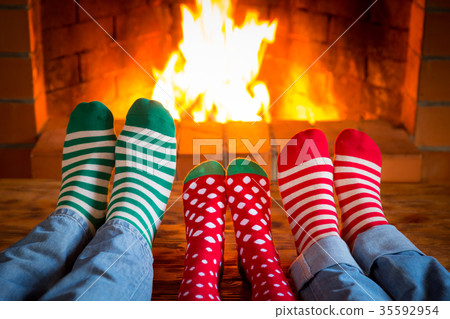 Family in Christmas socks near fireplace Family in Christmas socks near fireplace 35592954