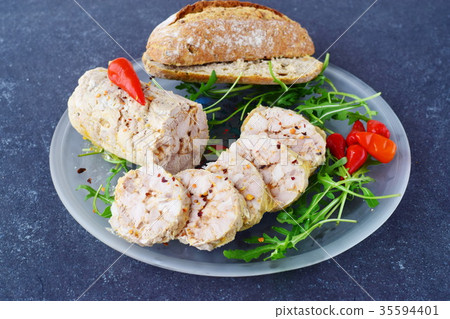 Homemade chicken roll with spices on a glass plate 35594401